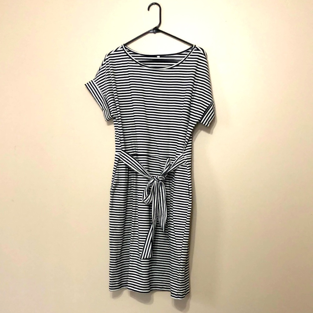 Black and white striped dress with waist tie and pockets.